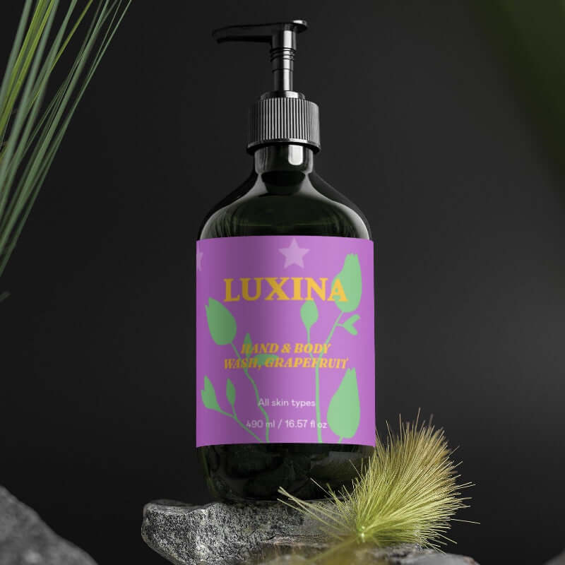 Bottle of Luxina hand and body wash with a purple label on a dark background
